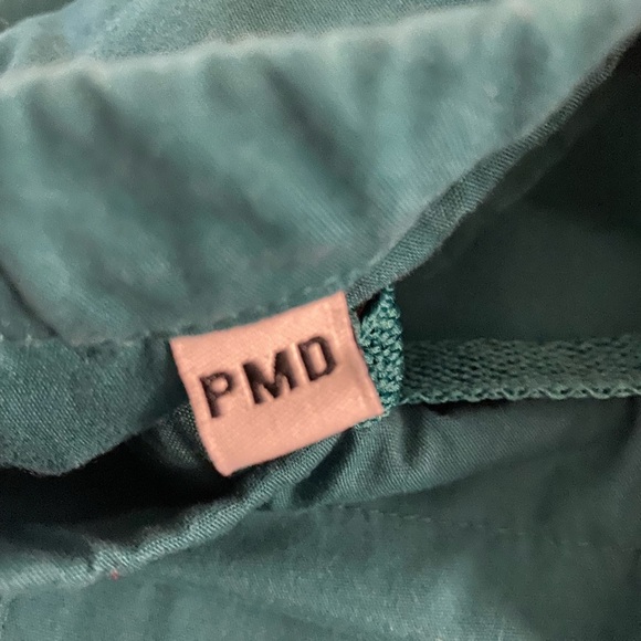 Two pairs of forest green scrub pants. - Picture 3 of 3